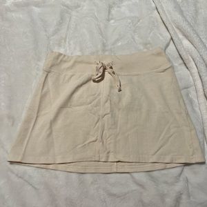 brandy melville cream mini skirt